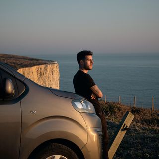 Lewis leaning against Eve and starting out to sea during sunset.