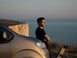 Lewis leaning against Eve and starting out to sea during sunset.